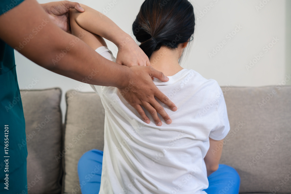 Fototapeta premium woman doing exercise at clinic with physiotherapist. help of a therapist trainer during a rehabilitation session.