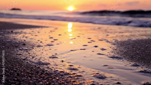 Cinematic close-up of sea wave leaving sparkling sand at sunset HDR
