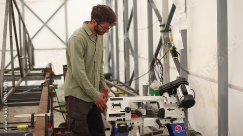 A man is working on a machine in a workshop