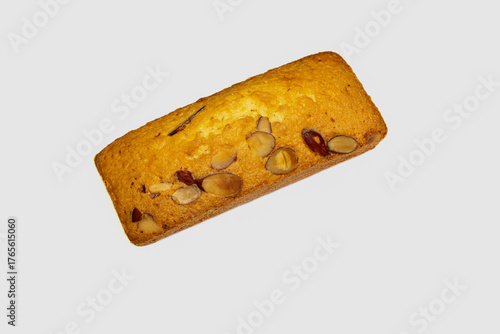 a pice of almond cake on white background .
