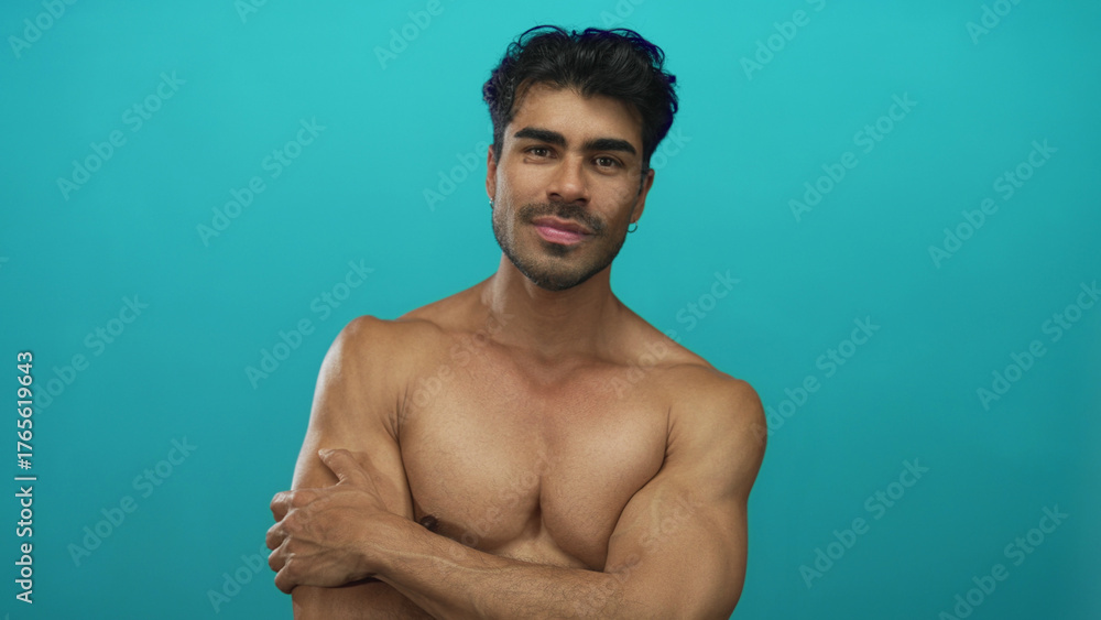 Fototapeta premium Man with closed eyes hugging his muscular chest with toned arms in studio and gentle smile; serenity.