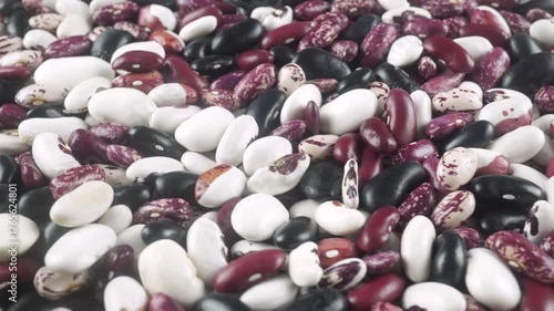 A Colorful Mix Of Dried Beans Including White Black And Variegated Variety.