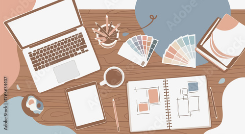 Workspace with laptop sketchbook and color swatches for creative design projects
