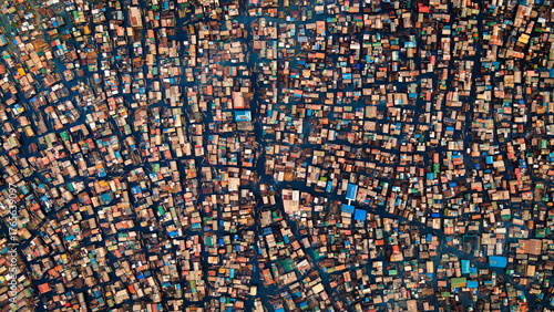 Aerial view of tightly packed buildings create a maze of colorful rooftops, reflecting the vibrant life below in this sprawling cityscape, Lagos, Lagos, Nigeria.