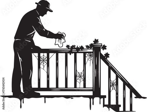 Silhouette of a man cleaning halloween decorations off of a porc