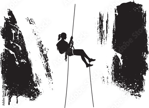 Silhouette of a woman rappelling down a textured cliff face with