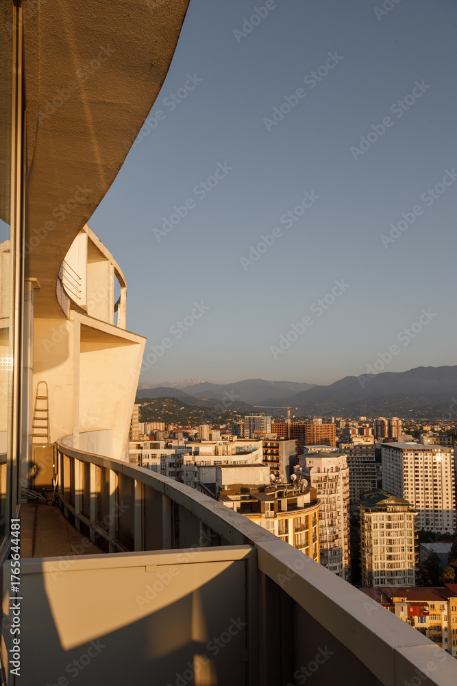 Fototapeta premium A Breathtaking Urban Skyline at Sunset with Majestic Mountains in the Background