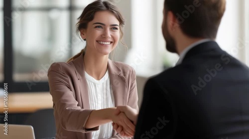 Smiling woman shaking hands in job interview