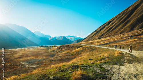 Wallpaper Mural Group of hikers walking along a remote path through Truso Valley, Georgia. Golden light, vast mountain views, and the spirit of peaceful adventure Torontodigital.ca
