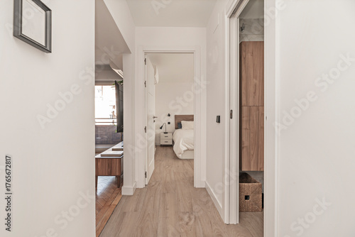 Bild auf Leinwand Narrow hallway with invisible integrated storage: pocket doors and drawers under