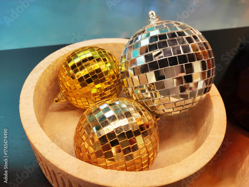 Decorative festive New Year shiny mirror disco ball with lots of small flat mirrors, Christmas tree decoration, on a blue background.