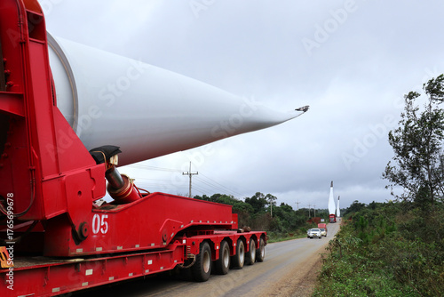 Wind Turbine Blades Transportation on the Red Trailer Truck