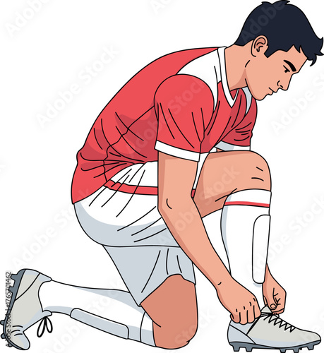Soccer player tying his shoe laces, ready to play