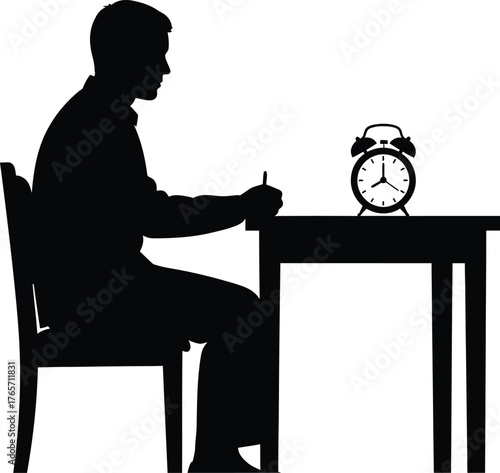 Silhouette of a person sitting at a desk writing with an alarm clock on the table