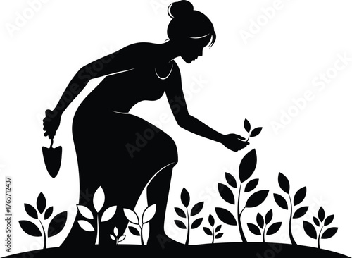 Silhouette of a woman tending to young plants in a garden with a trowel