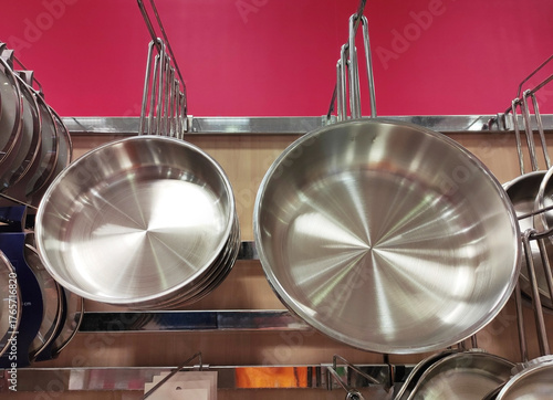 Shiny round metal steel cooking pots in the shop window