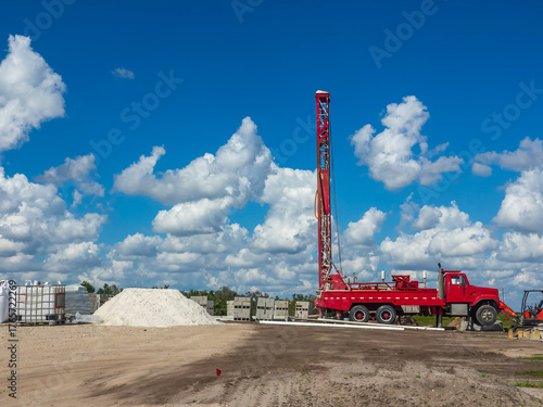 Water well drilling rig on the construction site of a new exurban house in southwest Florida, for motifs of locality and resources, and concepts of surface and self-sufficiency