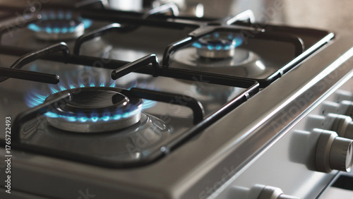 Close-up of a blue fire from a kitchen stove. 4 gas burners with a burning flame. economy concept.