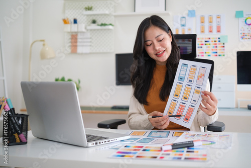 Smiling UX UI designer presenting mobile app interface prototypes during online meeting.