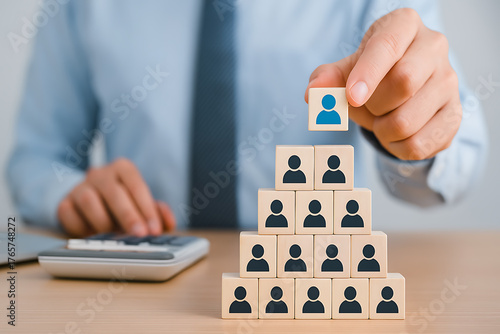 Human resource structure with wooden blocks forming pyramid symbolizing corporate teamwork organization and success