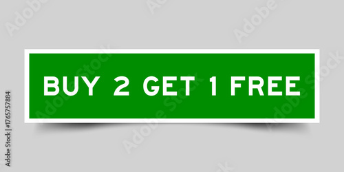 Green color square shape sticker label with word buy 2 get 1 free on gray background