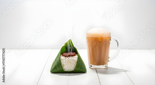Hot nasi lemak packet and frothy teh tarik on white wood