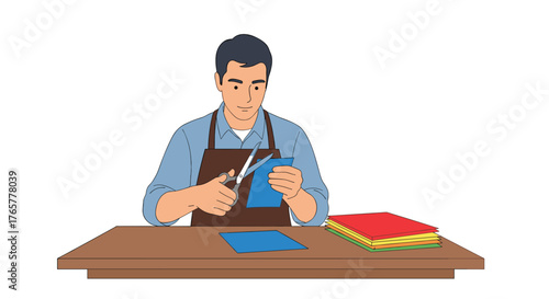 Man carefully cutting blue paper with scissors at a wooden table, creative crafting concept for DIY projects