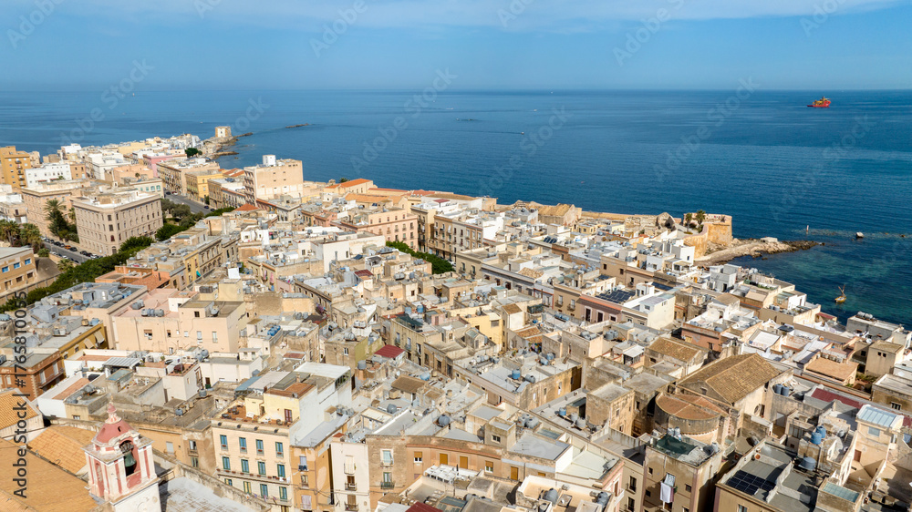 Obraz premium Aerial view of houses and buildings in the historic center of Trapani, Sicily, Italy. It is a beautiful city overlooking the Mediterranean Sea, with the sea stretching to the horizon.