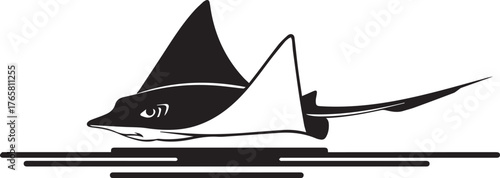 Graceful manta ray gliding through ocean waters creating a stunning silhouette