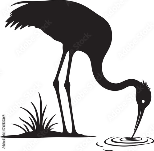 Black silhouette of a crane drinking water from ripples