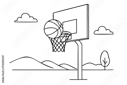 Basketball is in the air and is about to go through a hoop. The sky is cloudy and the background is a mountain range