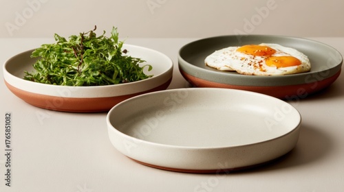 Korean street food, Three stylish ceramic plates with food and herbs displayed.