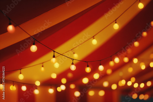 Festive Atmosphere with Glowing String Lights Hanging Beneath a Striped Event Tent Canopy