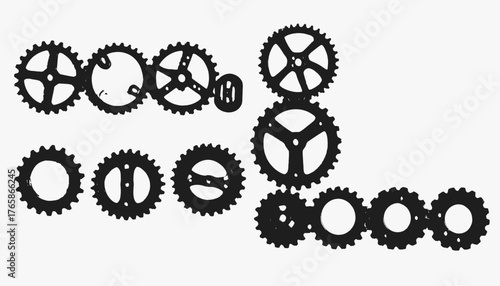 A black and white image displays several gears of different sizes and designs arranged randomly