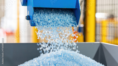 Plastic granules pouring from industrial hopper, manufacturing process, blue polymer, production facility, plastic industry, raw materials, extrusion, recycling, material processing, engineering