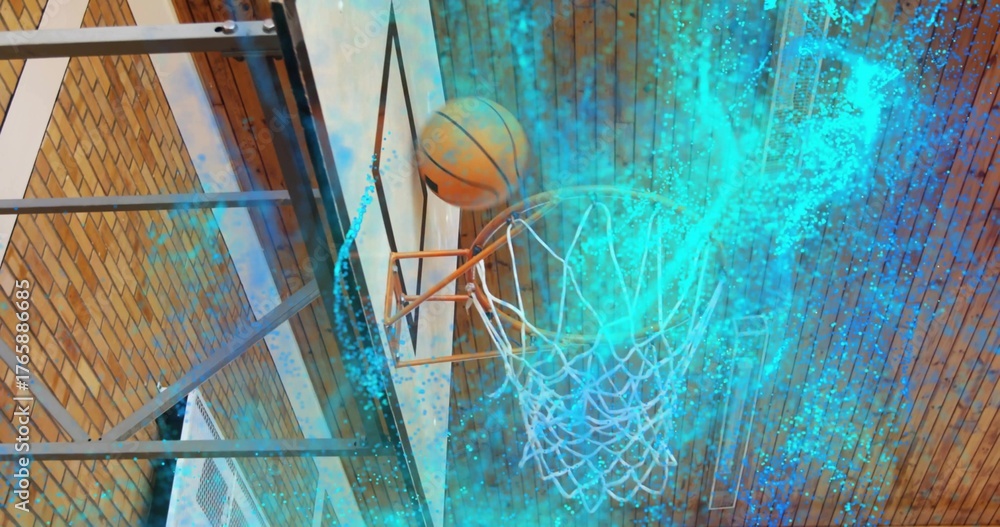 Fototapeta premium Descending basketball passing through orange rim and net in gym, with turquoise particle swirl