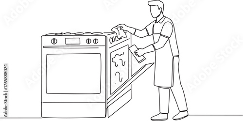 Diligent man meticulously cleans oven interior with unwavering f