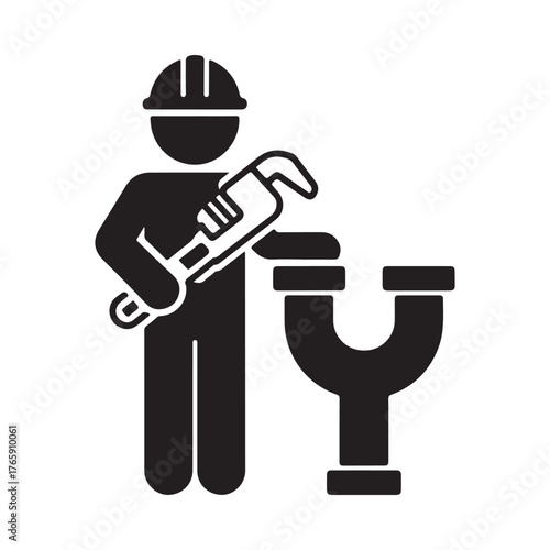 Plumber wearing hard hat holding wrench working on pipe fitting