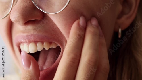 Girl scratching her face with fingers, showing problematic or irritated skin, close-up.