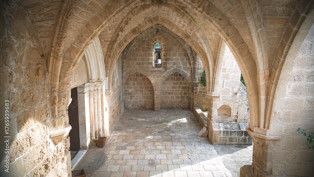 Fototapeta premium Sunlight illuminating stone arches and floor in Bellapais Abbey. Kyrenia District, Cyprus