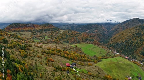 Scenic autumn mountain landscape with colourful fall forest in a mountain valley, Aerial hyperlapse