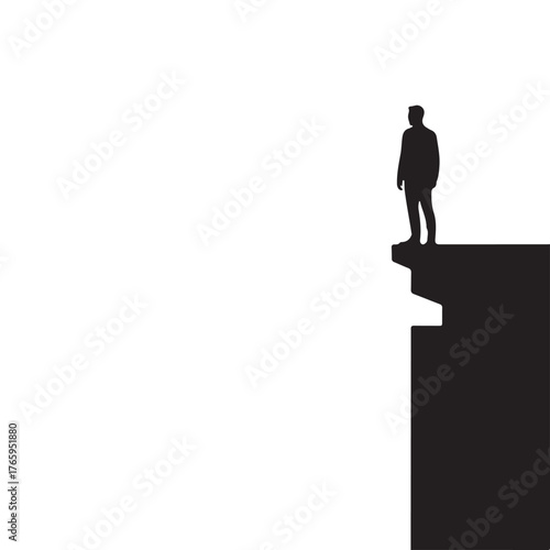 Conceptual silhouette of a solitary businessman standing on the edge of a cliff, symbolizing risk and future decisions