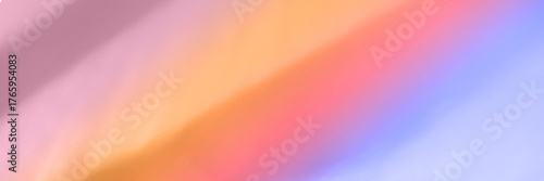 Abstract blurred pastel gradient with soft hues of pink orange and blue.