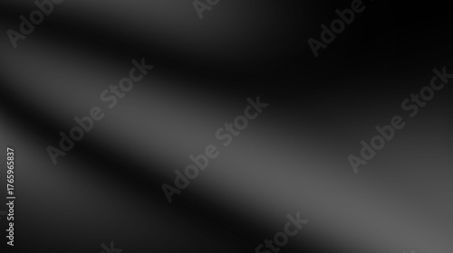 Abstract dark gray and black background with grain texture.