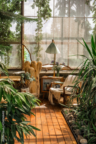 Rustic greenhouse reading nook with tropical foliage for concepts of comfort, serenity and eco-friendly interior