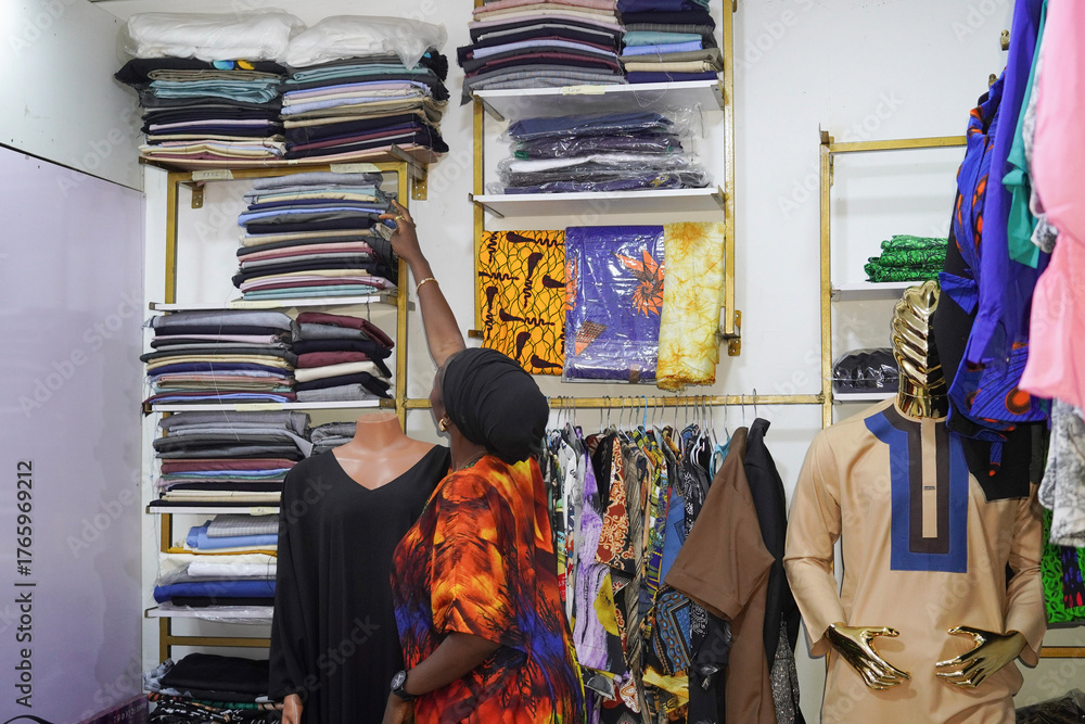 Naklejka premium A beautiful African female fashion designer working in her studio