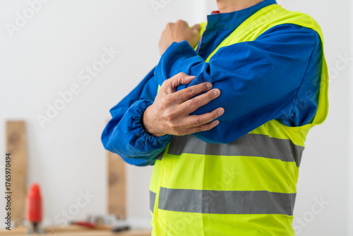 Canvas Print Hands, person and elbow pain with construction injury, work site accident or sprain with agony indoor