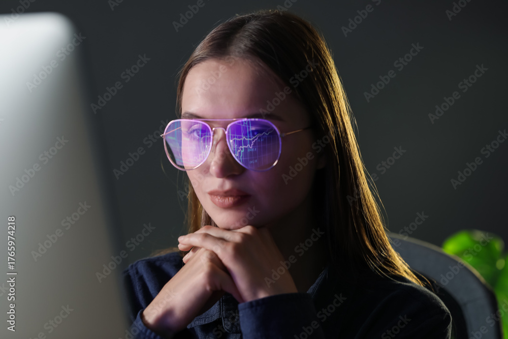 Naklejka premium Young woman wearing glasses with reflection working with computer on grey background