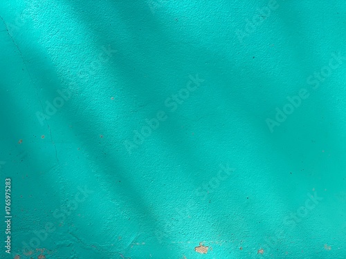 An abstract blue background. A teal green wall.