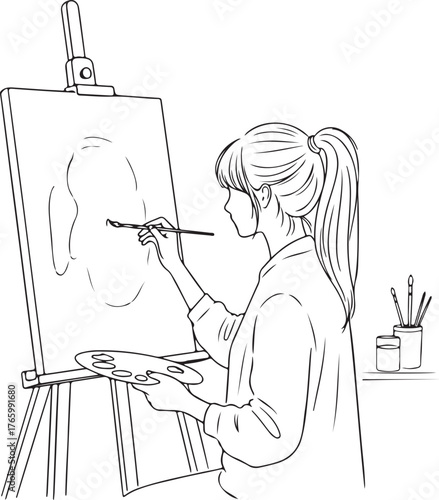 Young woman painting artwork on canvas in studio, creating modern masterpiece